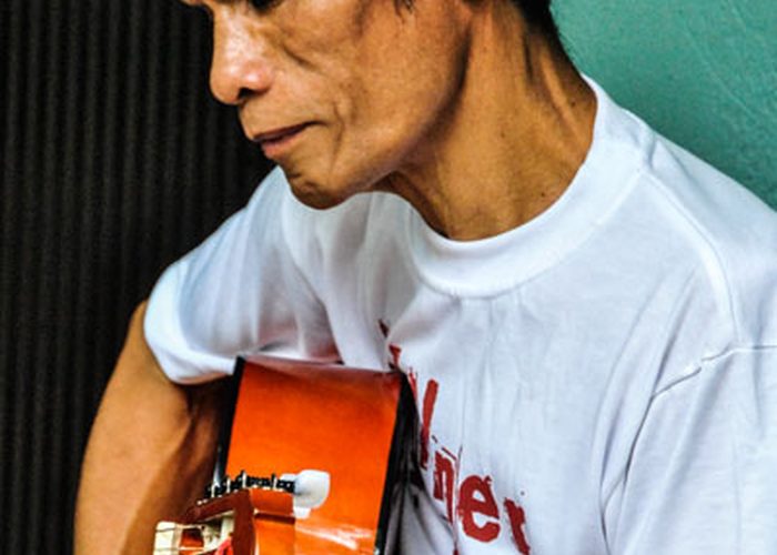 A resident playing the guitar